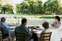 The Burch family sitting around a table looking at old images of a vineyard